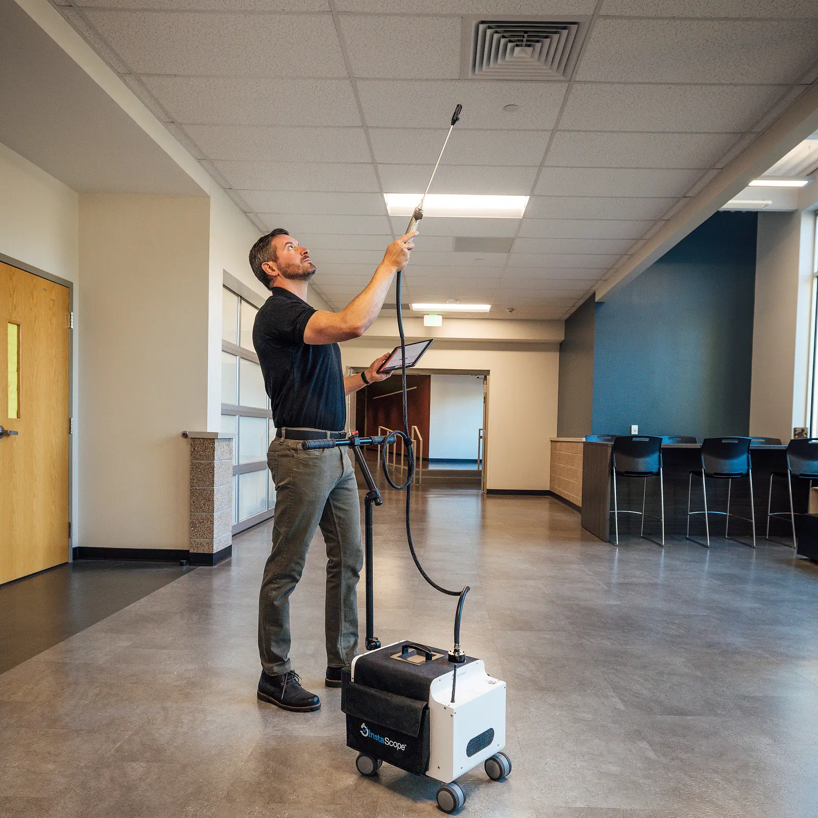 MoldCure technician scanning a ceiling vent with the InstaScope wand